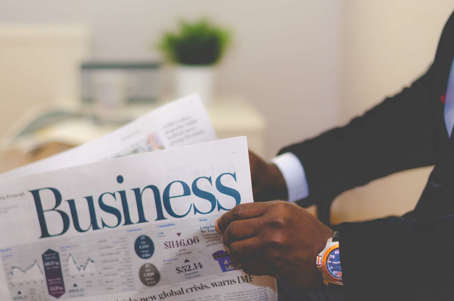 person holding white and blue business paper